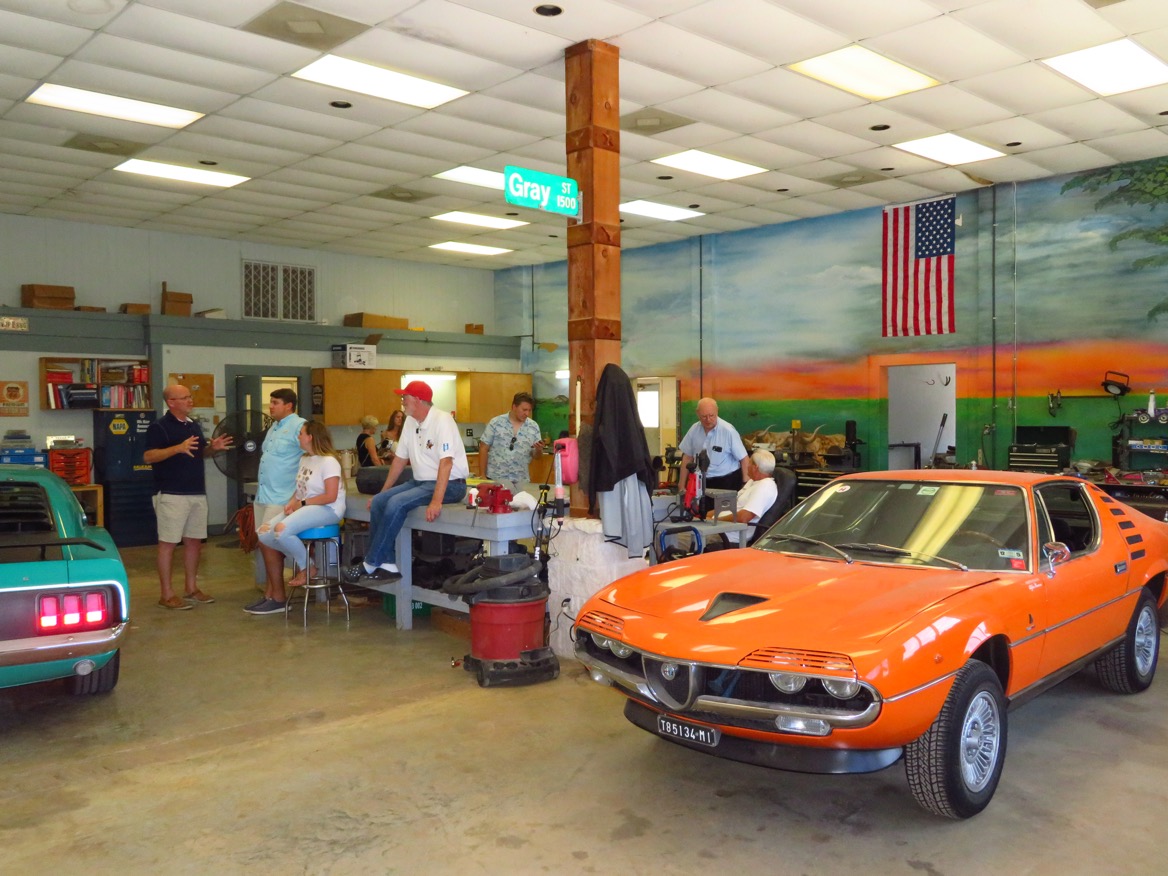 14 After lunch the crowd moved indoors to watch the car repairs